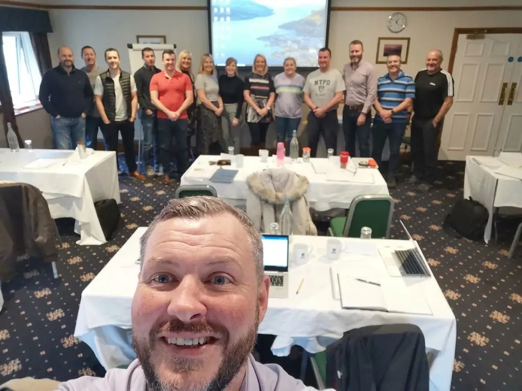 Gavin Thomas taking a selfie with a training group at the end of a course